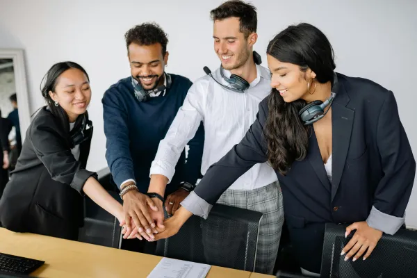 Free stock image of people putting their hands together.